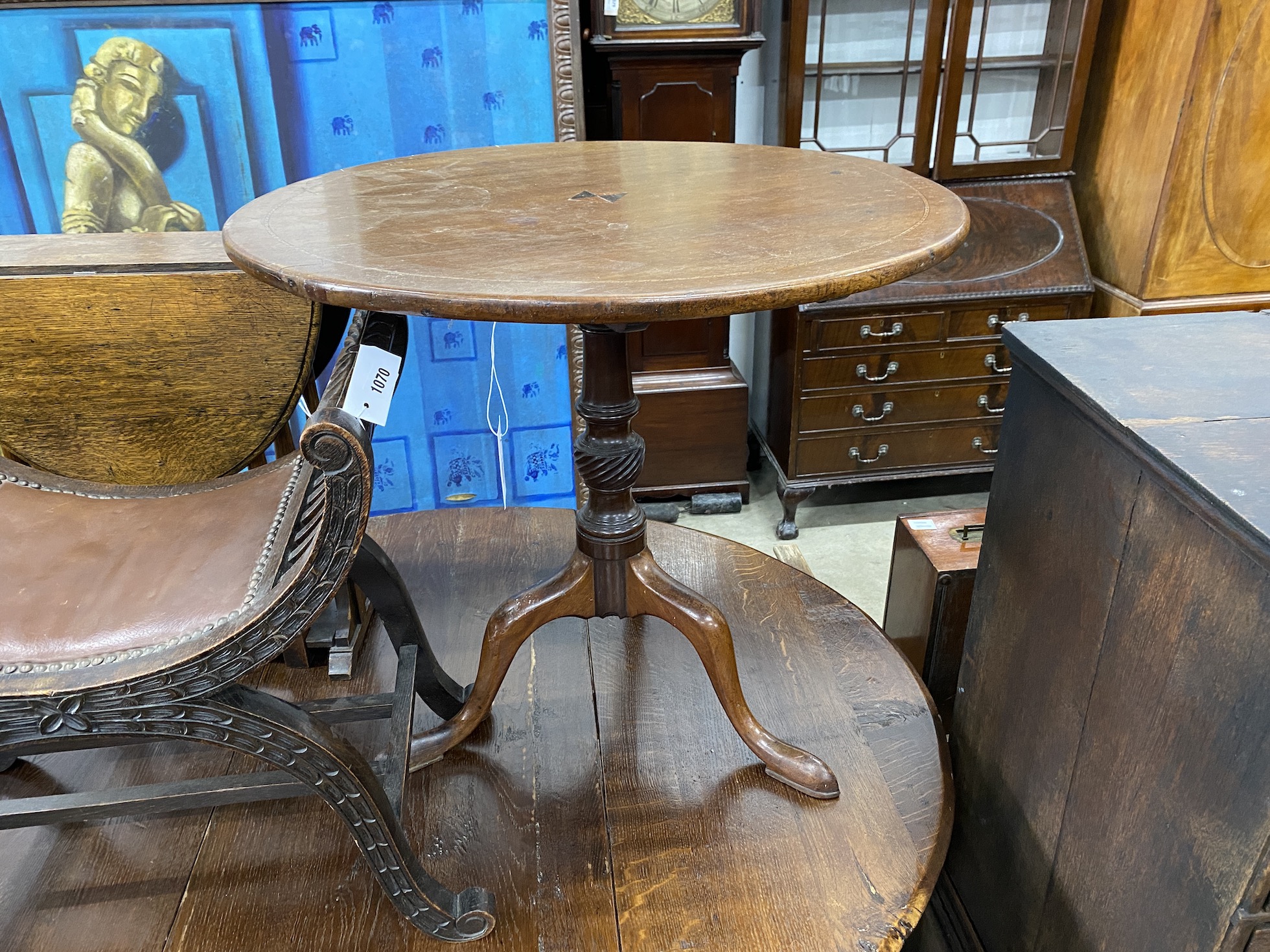 A George III circular mahogany tilt top tea table, diameter, 76cm, height 69cm